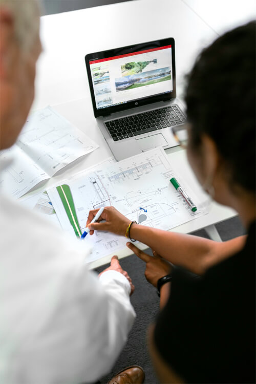 Two engineers discussing a plan in an engineering firm